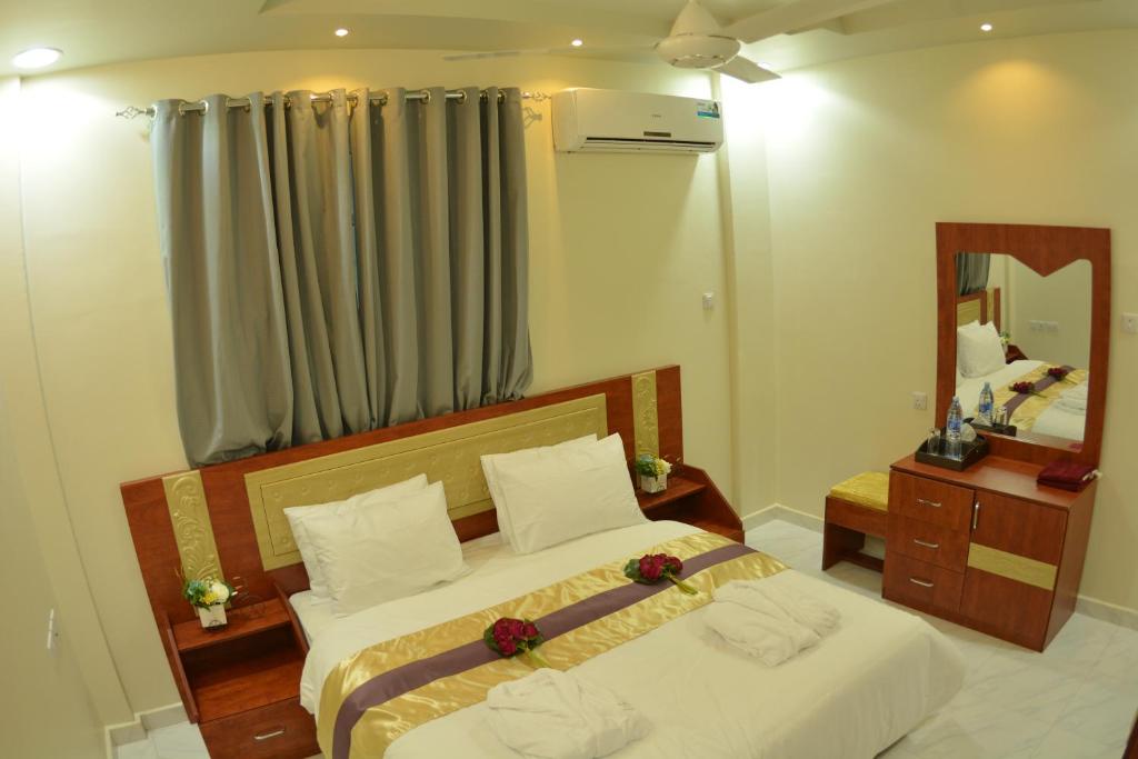 Postel nebo postele na pokoji v ubytování Bahla Jewel Hotel Apartments