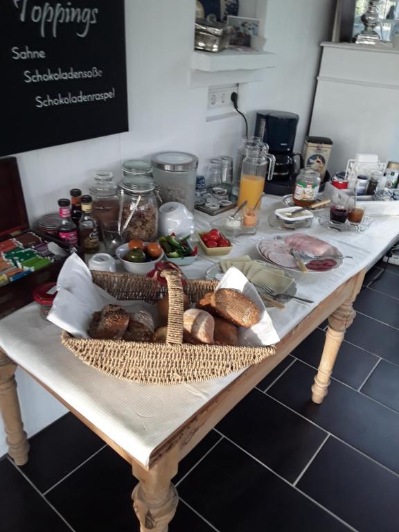 a table with bread and other food on it at Villa Jani b&amp;b in Breitscheid