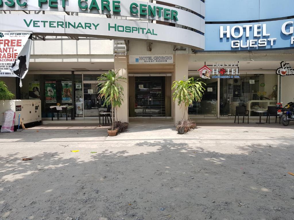un centre d'hôtel avec des palmiers devant lui dans l'établissement Hotel Giorgio, à General Santos