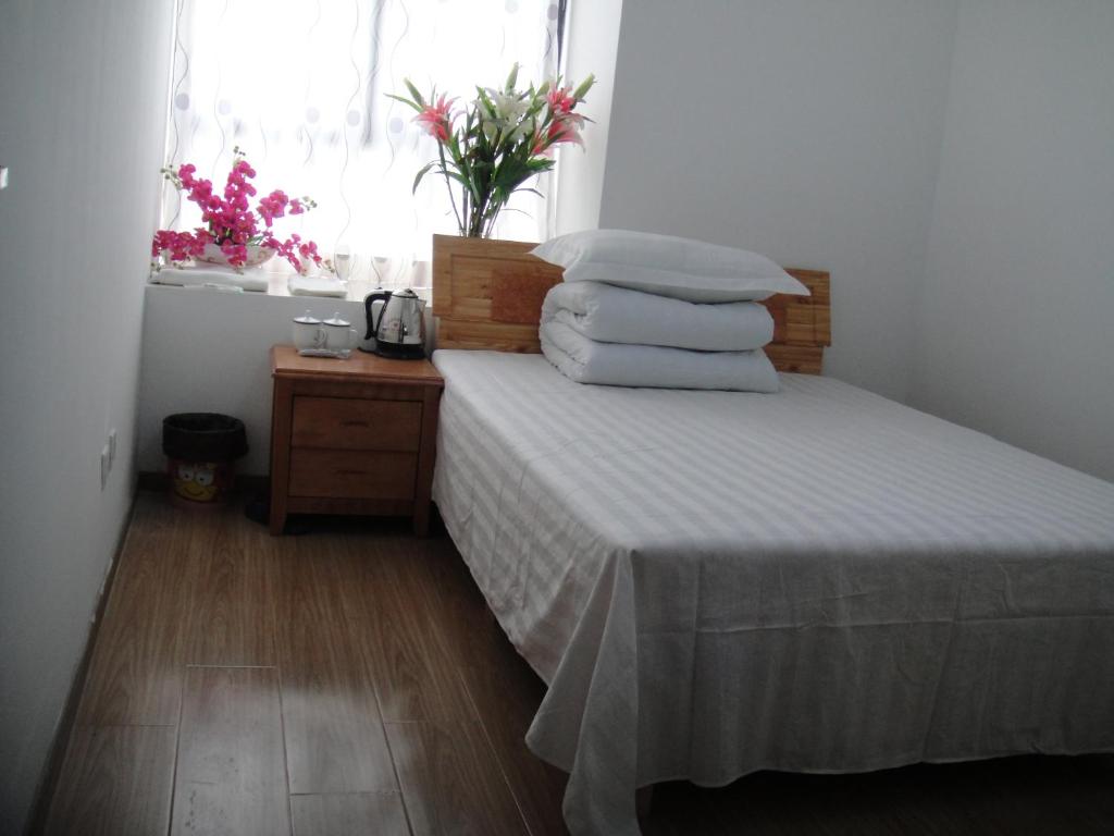 A bed or beds in a room at Hefei Vanward Fashion Short Rent