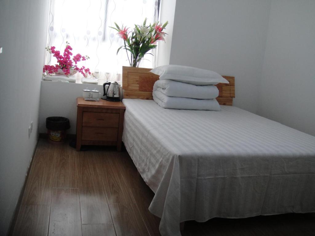 Uma cama ou camas num quarto em Hefei Vanward Fashion Short Rent