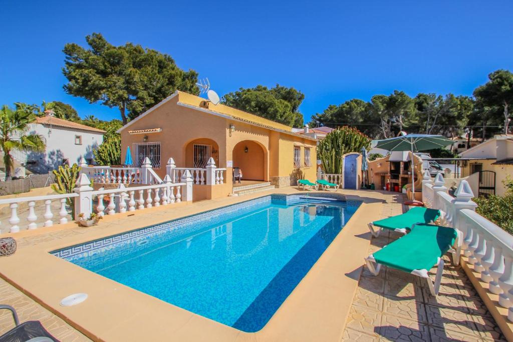 a villa with a swimming pool and a house at Sofia - holiday home with private swimming pool in Moraira in Moraira