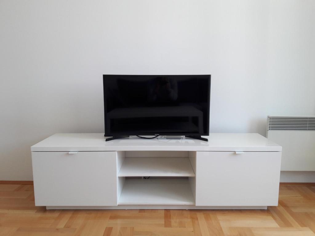 a white entertainment center with a television on top at Apartman Senjak in Pirot
