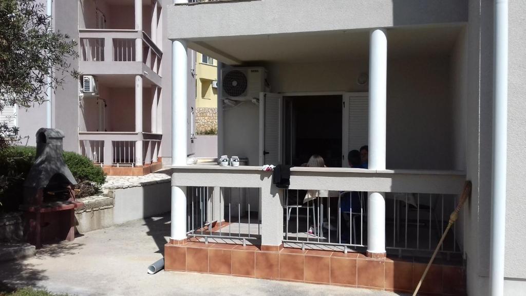 a balcony of a building with people in it at Apartman Lovro in Novalja