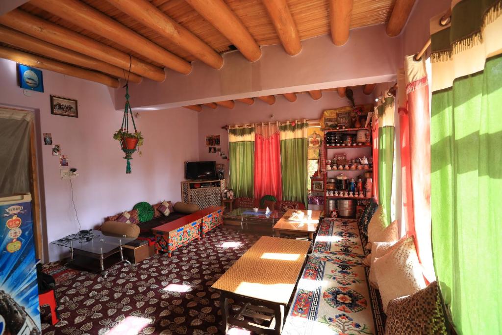a living room filled with furniture and decor at Lhachik Guest House in Leh
