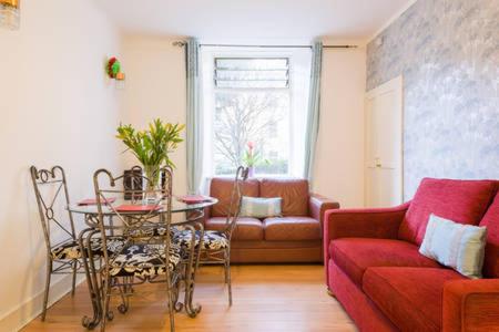 un salon avec un canapé et une table dans l'établissement Watson Crescent, à Édimbourg