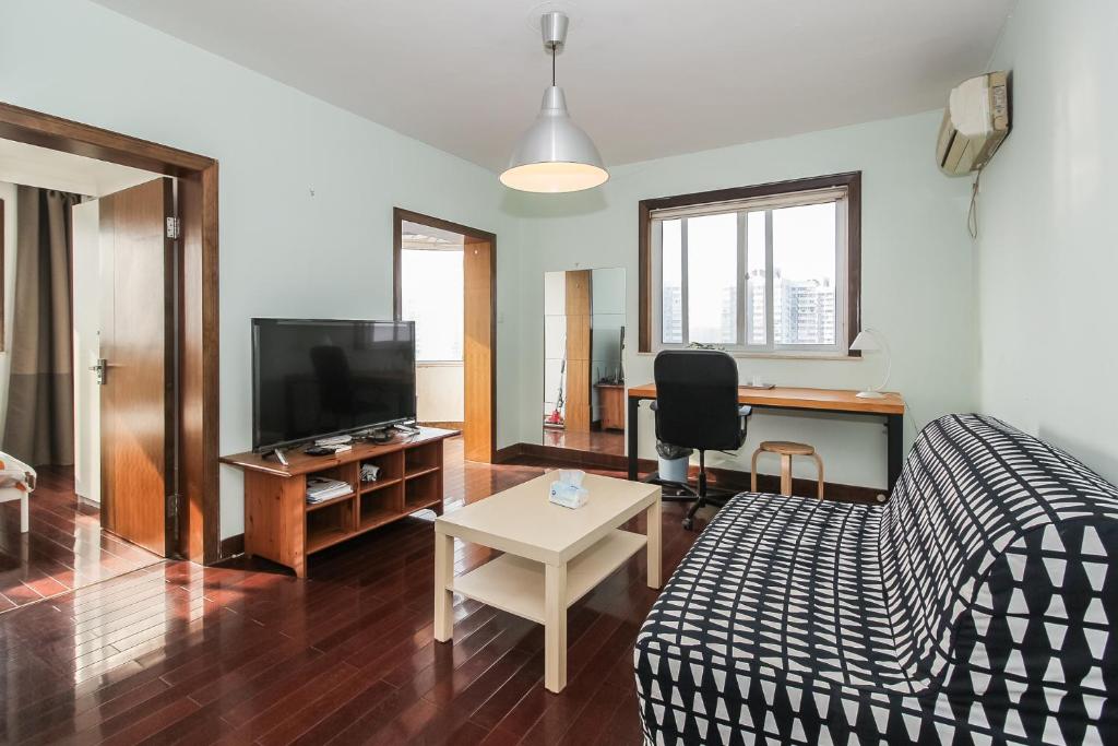 a living room with a couch and a tv at iNestin Shanghai Apt Hongfeng Road in Shanghai