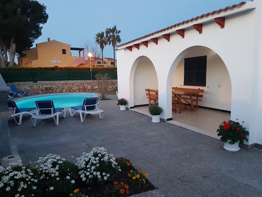 a patio with a pool and a house at Villa Samba in Cala en Blanes