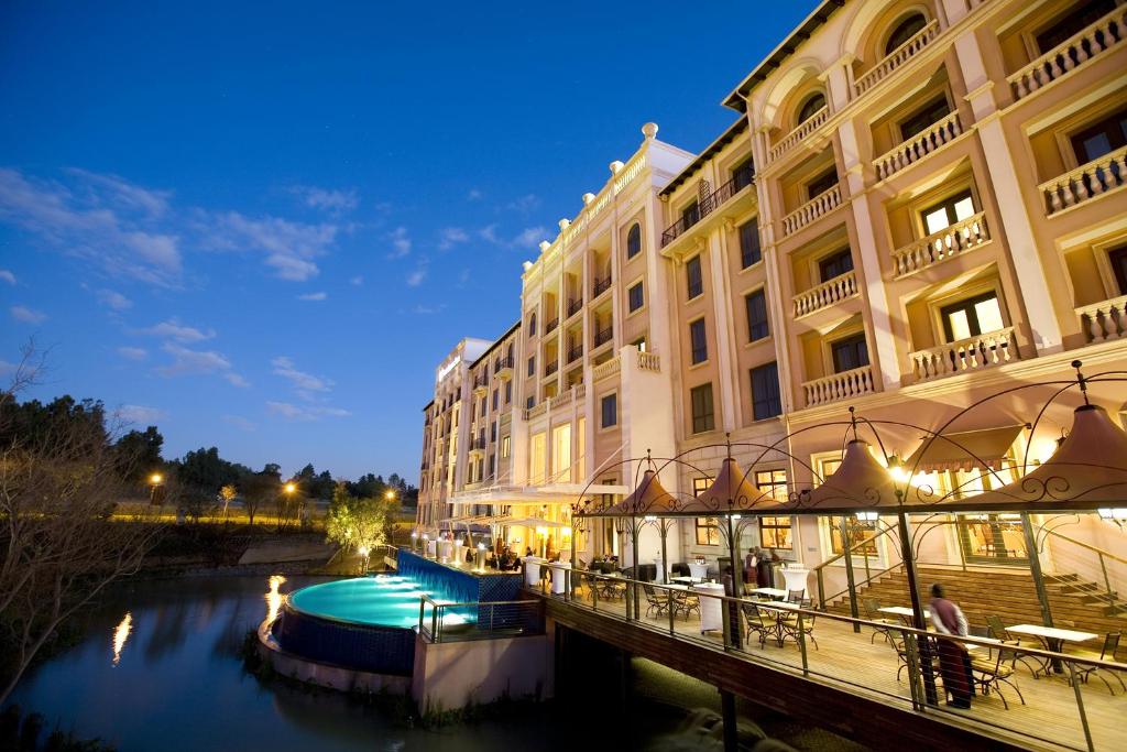 a boat in the water near a large building at Pivot Hotel Montecasino in Johannesburg