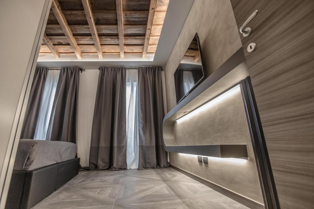 a room with a bed and a tv on a wall at DaVinci Apartament near Duomo in Milan