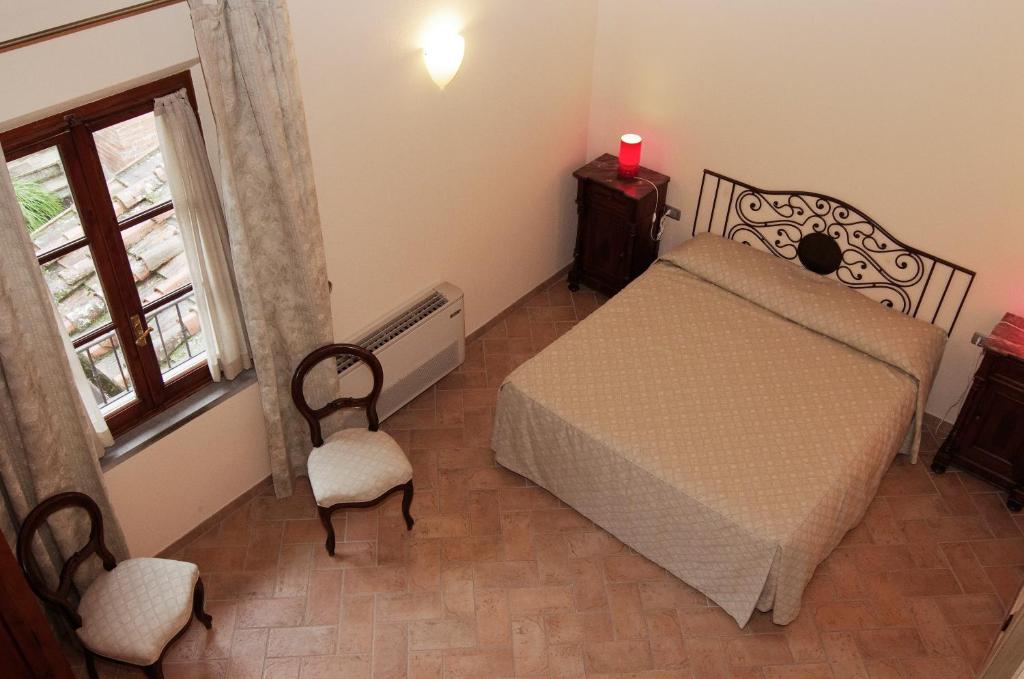 A bed or beds in a room at Bacco a Petroio