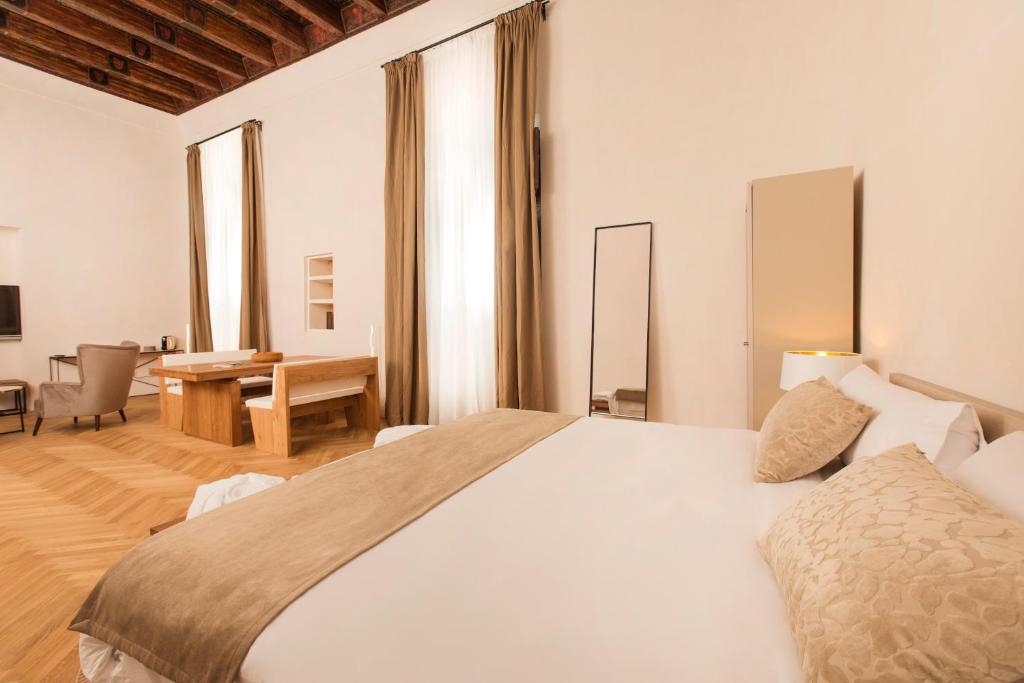 a bedroom with a large white bed and a desk at ICON Rosetó in Palma de Mallorca