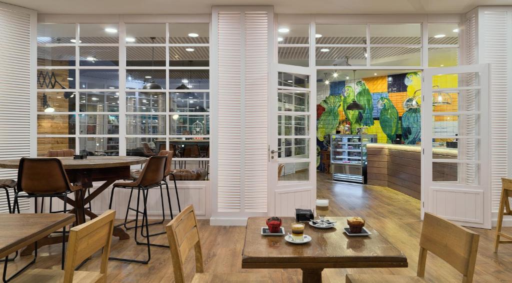 a dining room with tables and chairs and a mural at H10 Playa Esmeralda - Adults Only in Costa Calma