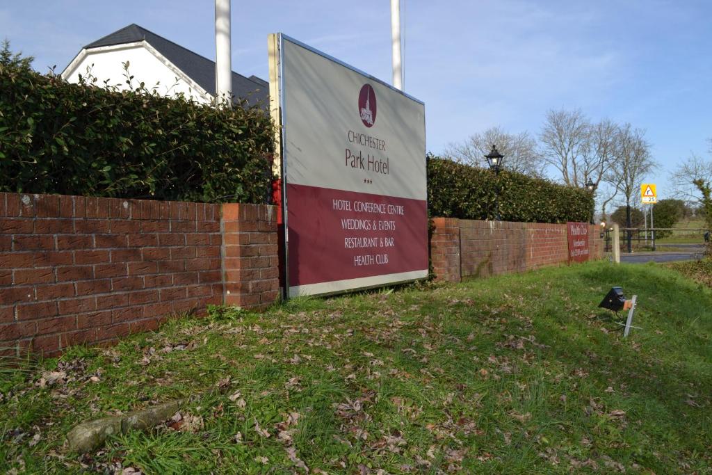 a sign on a brick wall in front of a house at Chichester Park Hotel in Chichester