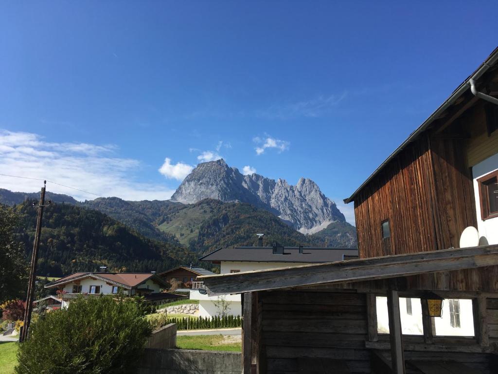 a view of a mountain from a village with a house at Mountain Blast in Kirchdorf in Tirol