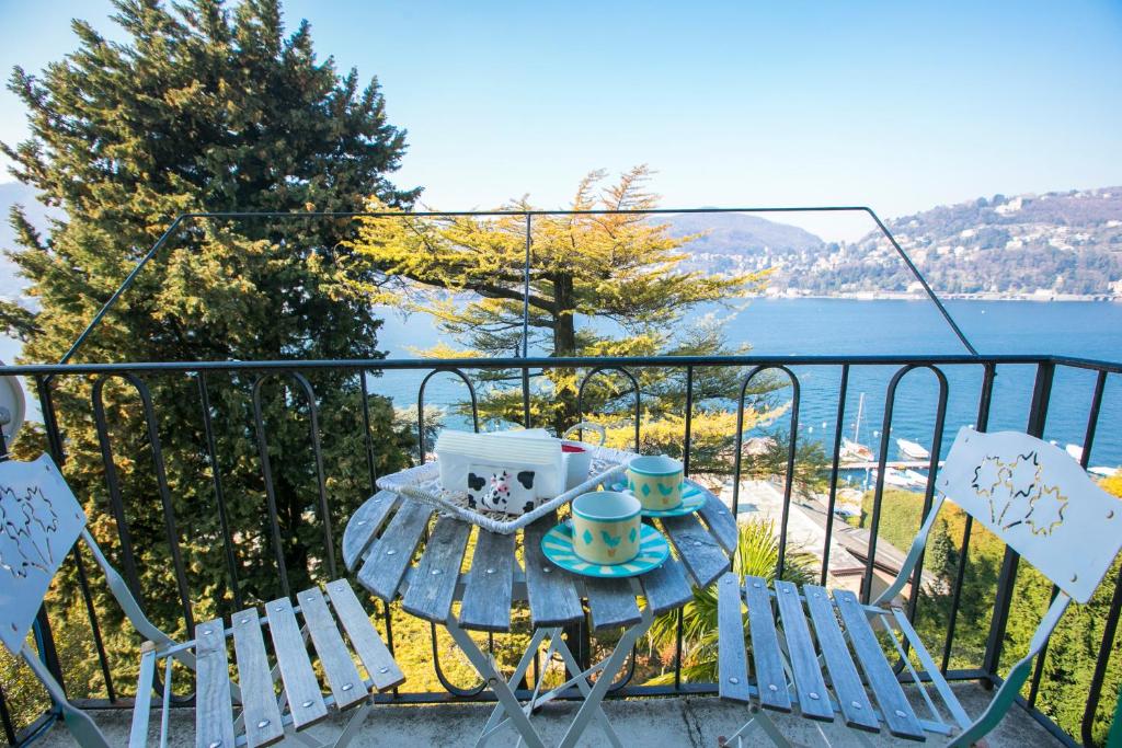a table and chairs on a balcony with a view of the water at La Vista in Como