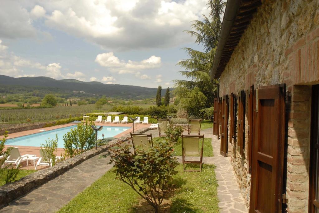 a patio with a view of the water at Relais Borgo Di Toiano in Sovicille