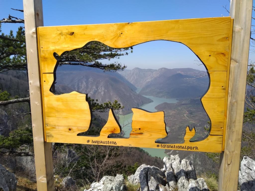 a sign with a picture of a bear on a mountain at Viola i Detelina Apartments in Perućac
