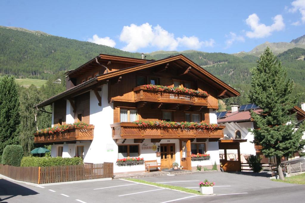 a large building with flowers on the balconies on it at Haus Sonnwend in Sölden