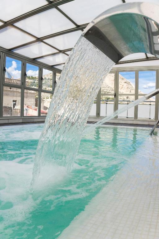 a water fountain in a swimming pool at Hospes Amérigo, Alicante, a Member of Design Hotels in Alicante