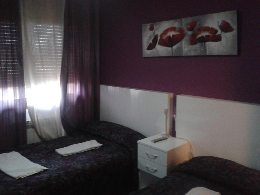 Postel nebo postele na pokoji v ubytování Hostal Texas 2