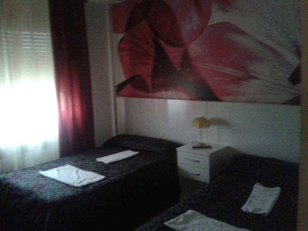 Postel nebo postele na pokoji v ubytování Hostal Texas 2
