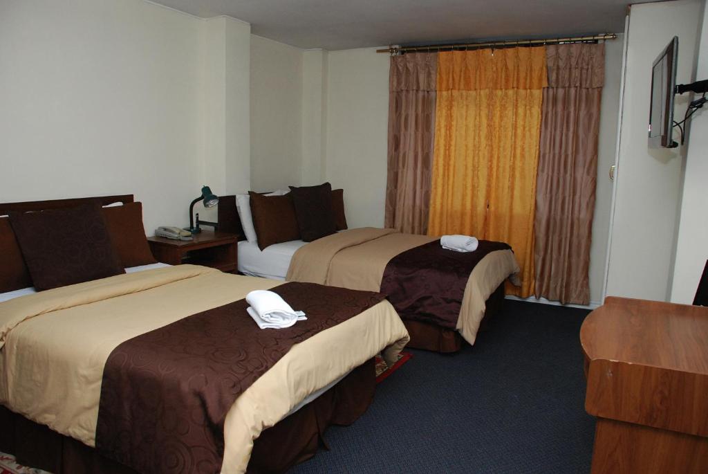 Postel nebo postele na pokoji v ubytování Hotel Bonaventure