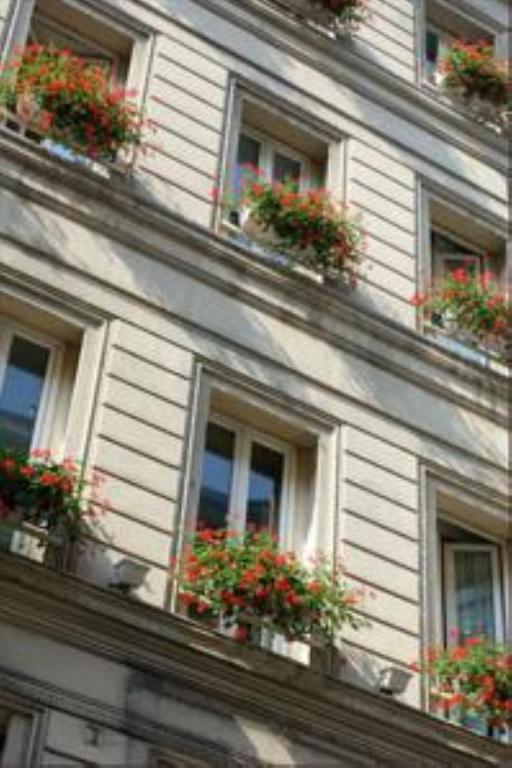 a building with windows with flower pots on it at Hôtel Royal Opéra in Paris