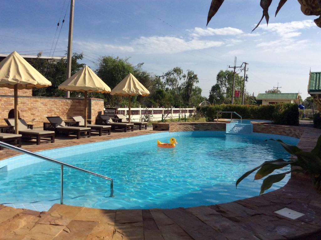 eine Person in einem Pool in der Unterkunft The Orchid Resort & Relax in Maha Sarakham