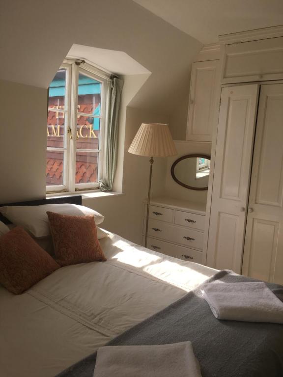 a bedroom with a large bed with a window at The Steam Packet in Littlehampton