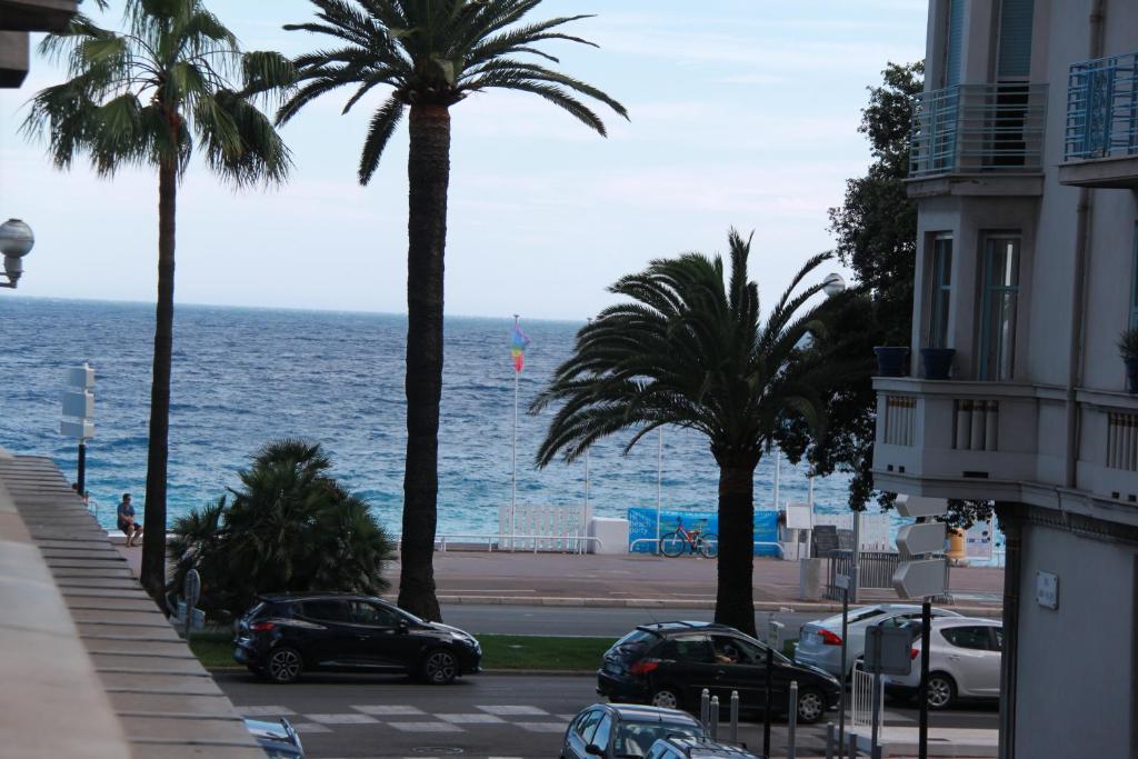 a view of a street with palm trees and the ocean at Apartment Saint Philippe 2 in Nice
