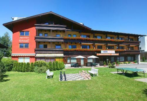 a large building with a lawn in front of it at Appartement Kristall in Zell am See