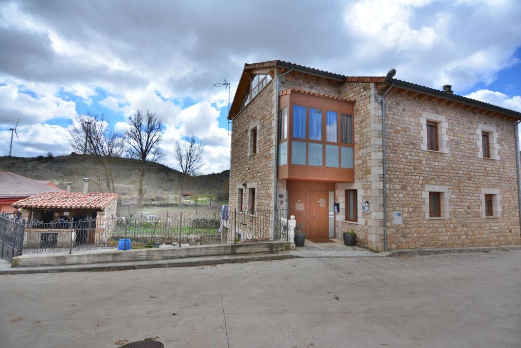 a brick building with a lot of windows on it at Hotel Rural Valles del Cid in Nuez de Arriba 