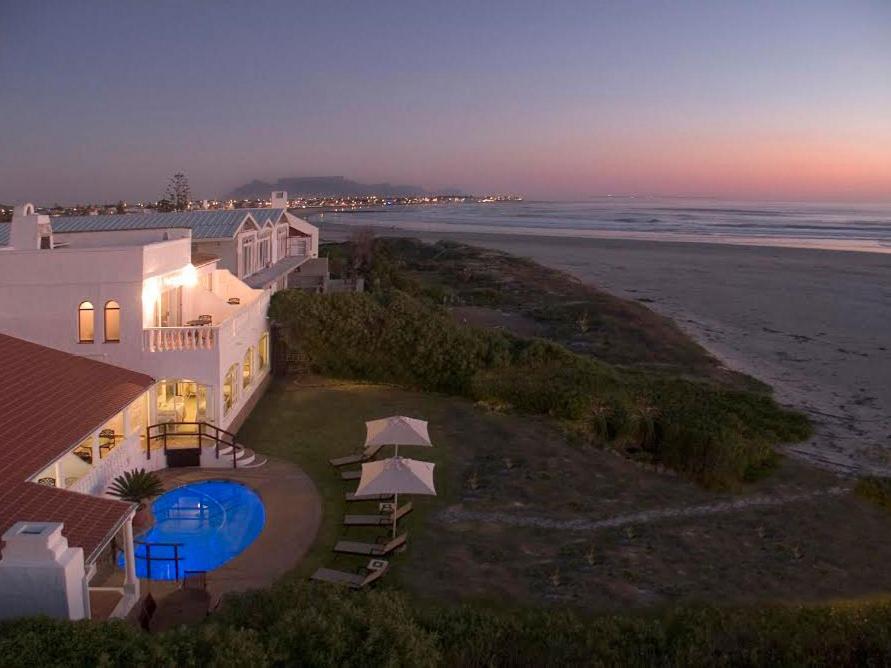 an aerial view of a house next to the beach at The Beach Villa in Melkbosstrand