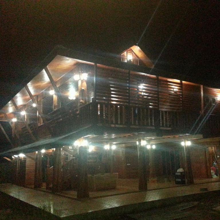 a building with a balcony at night with lights at Huanmaisakngam Resort in Ban Buak Khang