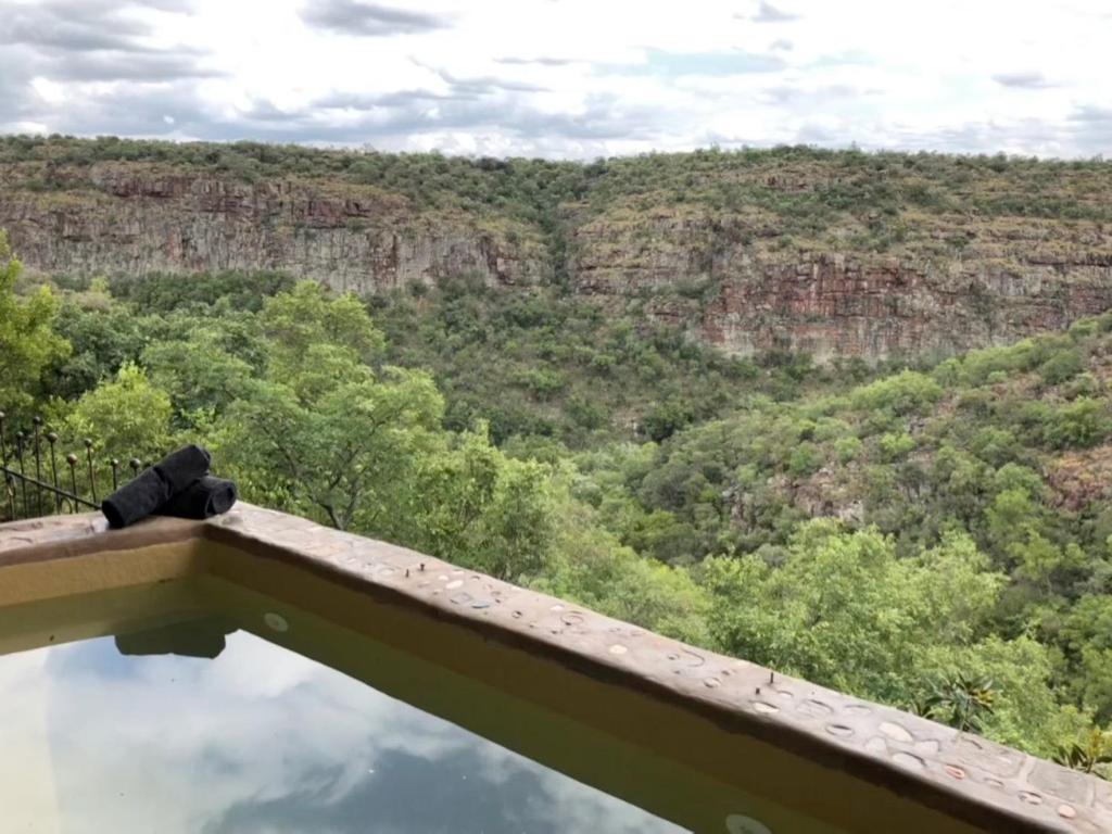 a view of the blue mountains from a viewing deck at Leopards Rock Bush Boutique in Bela-Bela