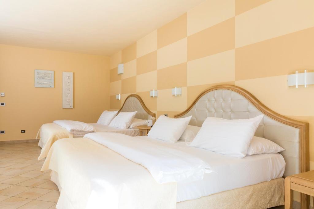 Ein Bett oder Betten in einem Zimmer der Unterkunft Park Hotel Argento