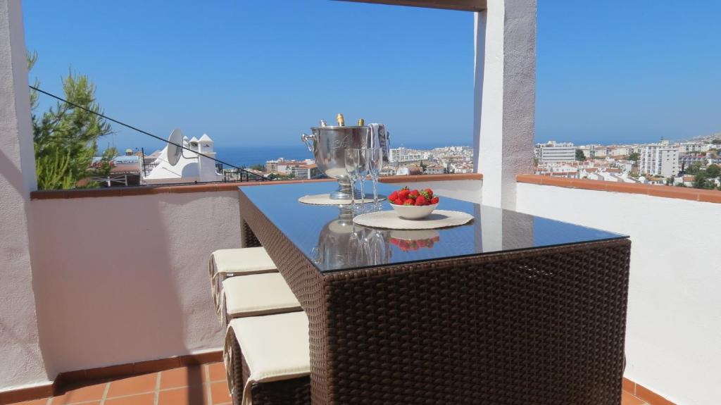 a balcony with a table and chairs on a balcony at Casa Aljamar 11C in Nerja