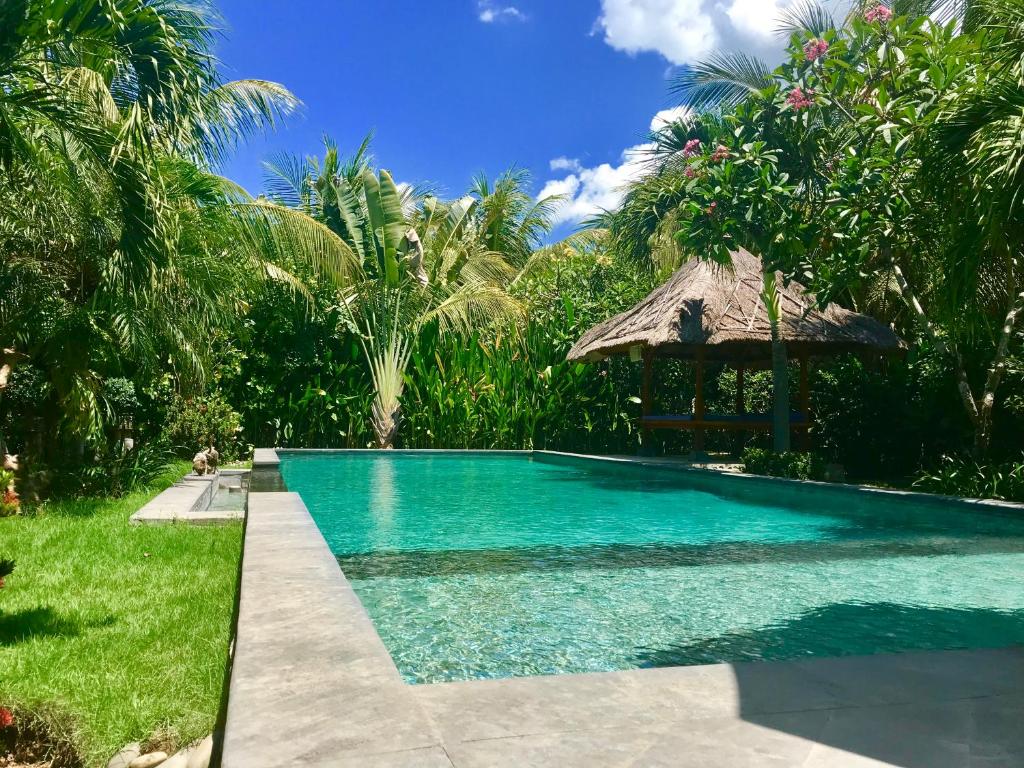 a swimming pool with a gazebo in a resort at Villa Adi in Amed