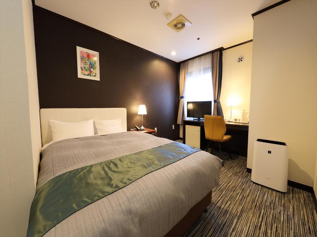 Postel nebo postele na pokoji v ubytování Garden hotel Shiunkaku Higashimatsuyama