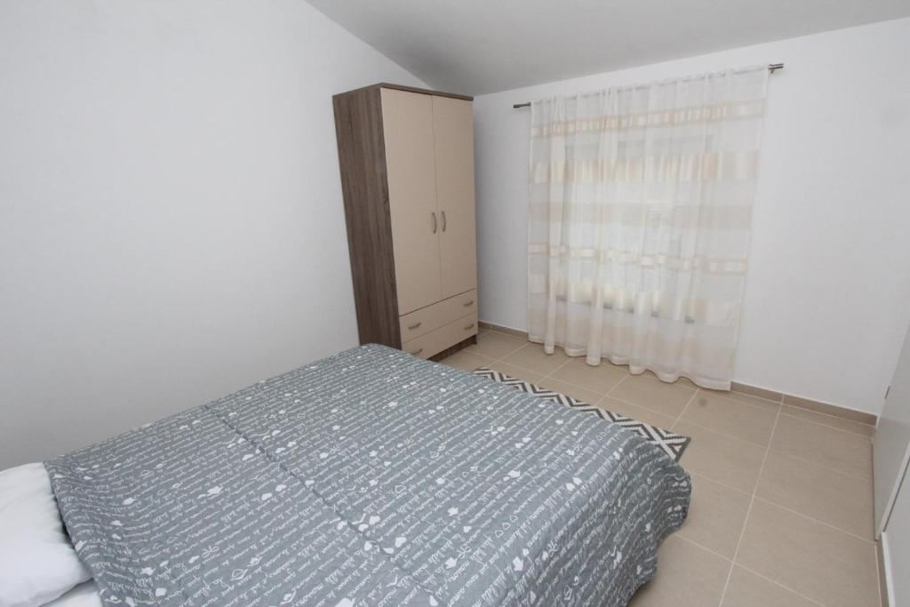 Łóżko lub łóżka w pokoju w obiekcie Apartments Sorriso