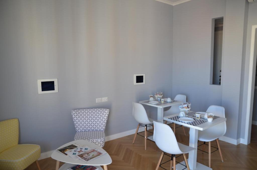 a room with a table and chairs and a sink at Room 56 in Bari