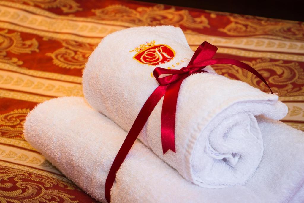 a stack of white towels with a red ribbon at Hotel U Krále in Jičín