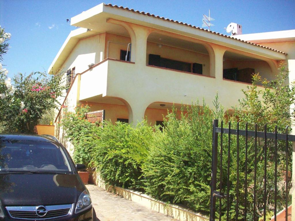 a car parked in front of a house at VIA BOCCACCIO 16 in Budoni
