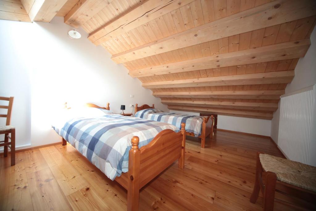 Postel nebo postele na pokoji v ubytování Albergo Diffuso Valcellina e Val Vajont in Erto