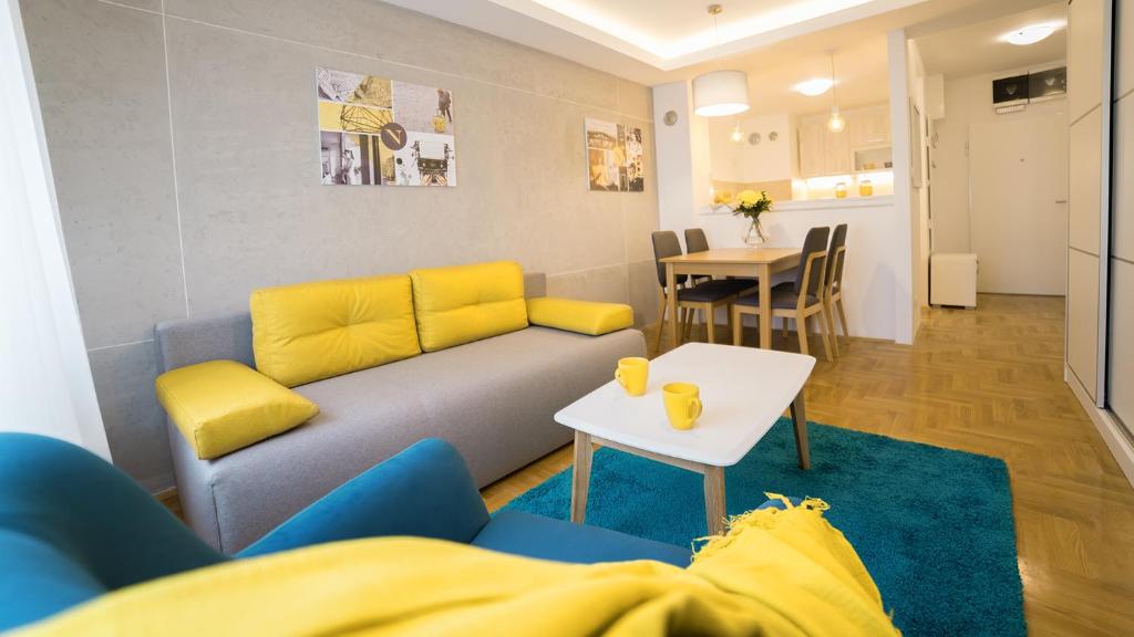a living room with a couch and a table at Novel Inn in Belgrade