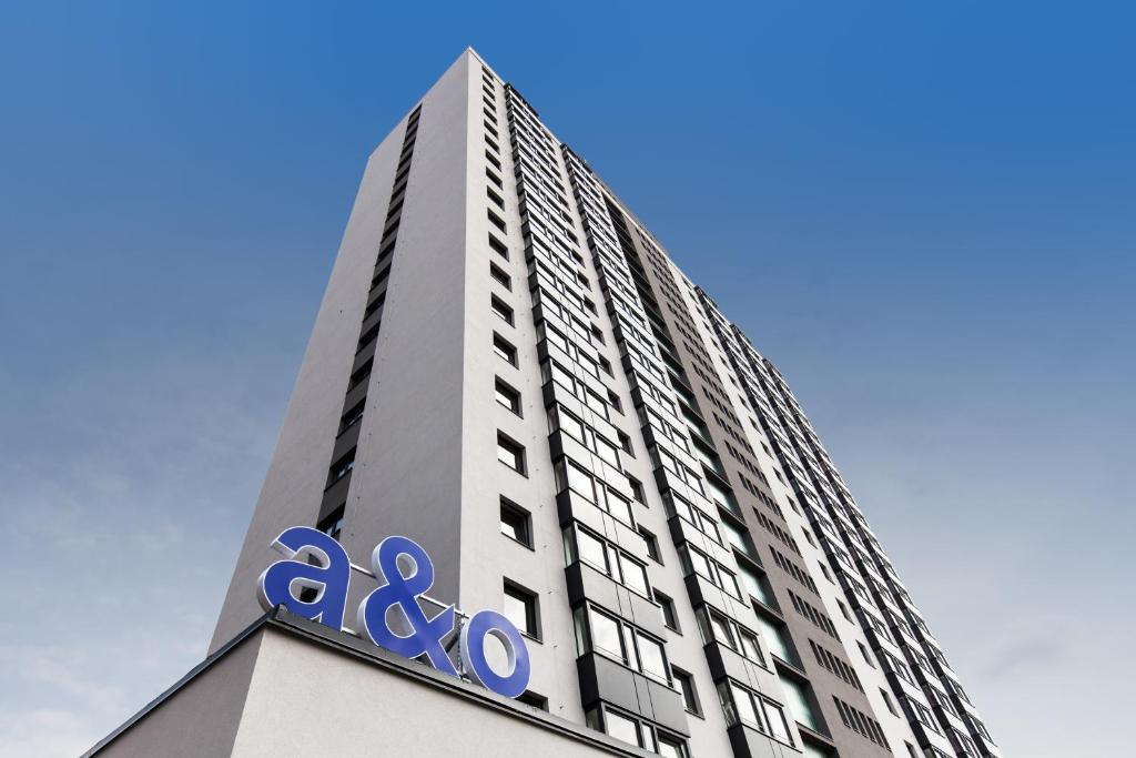 a tall white building with aania sign on it at a&o Prague Rhea in Prague