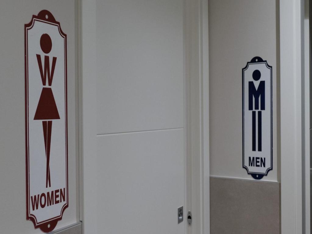 a door with signs on the side of it at Hotel Buena Onda in Peschiera del Garda