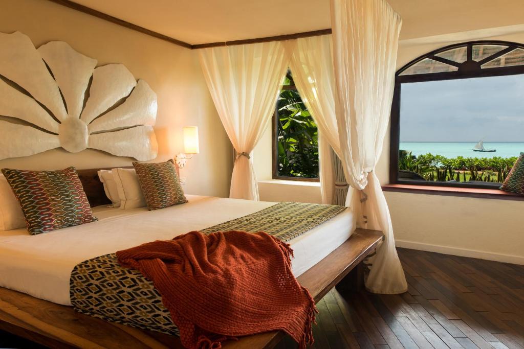 Essque Zalu Zanzibar tesisinde bir odada yatak veya yataklar