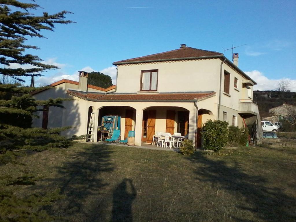 a large white house with a large yard at gîte en sud Ardèche in Ruoms